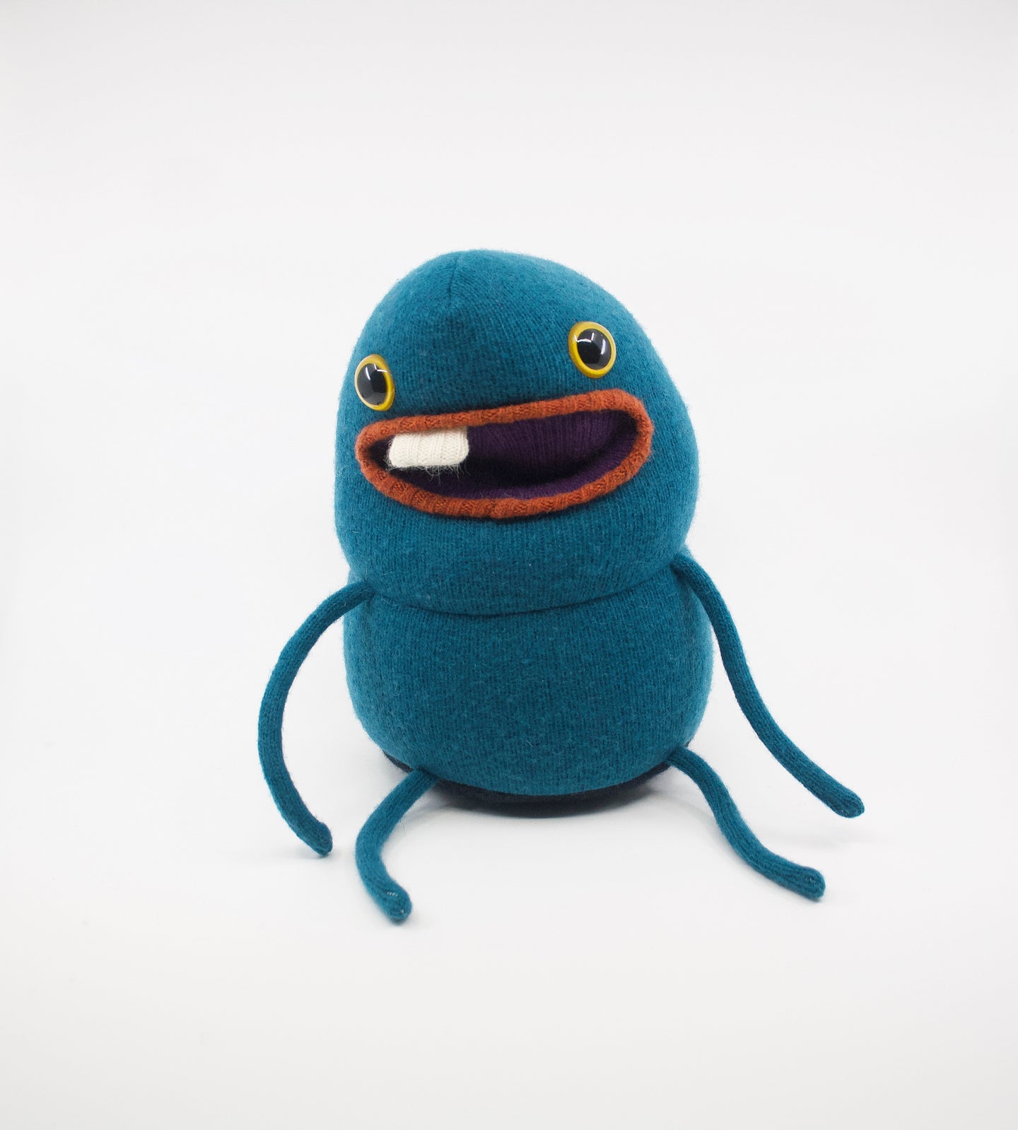 friendly teal coloured monster with pocket mouth