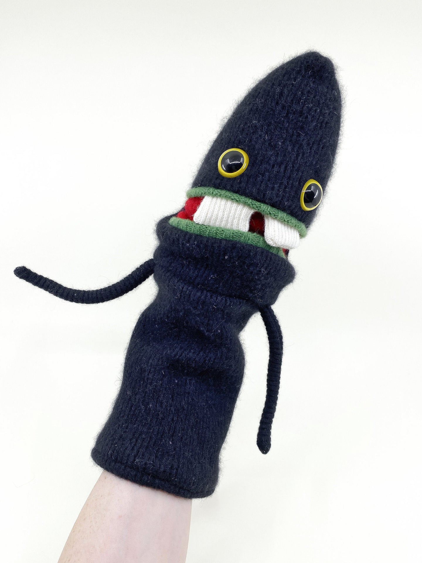 funny monster hand puppet with teeth made from a black wool sweater 