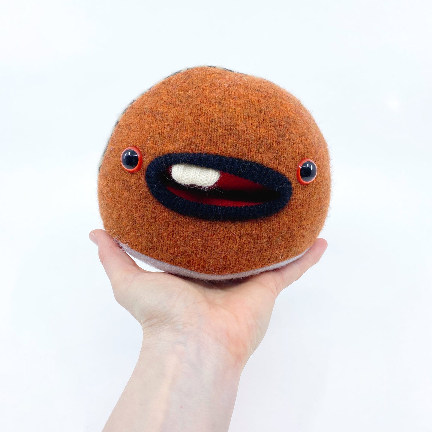 small orange stuffed monster plush toy