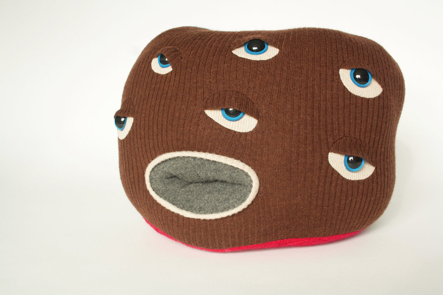 brown stuffed monster plush with six eyes