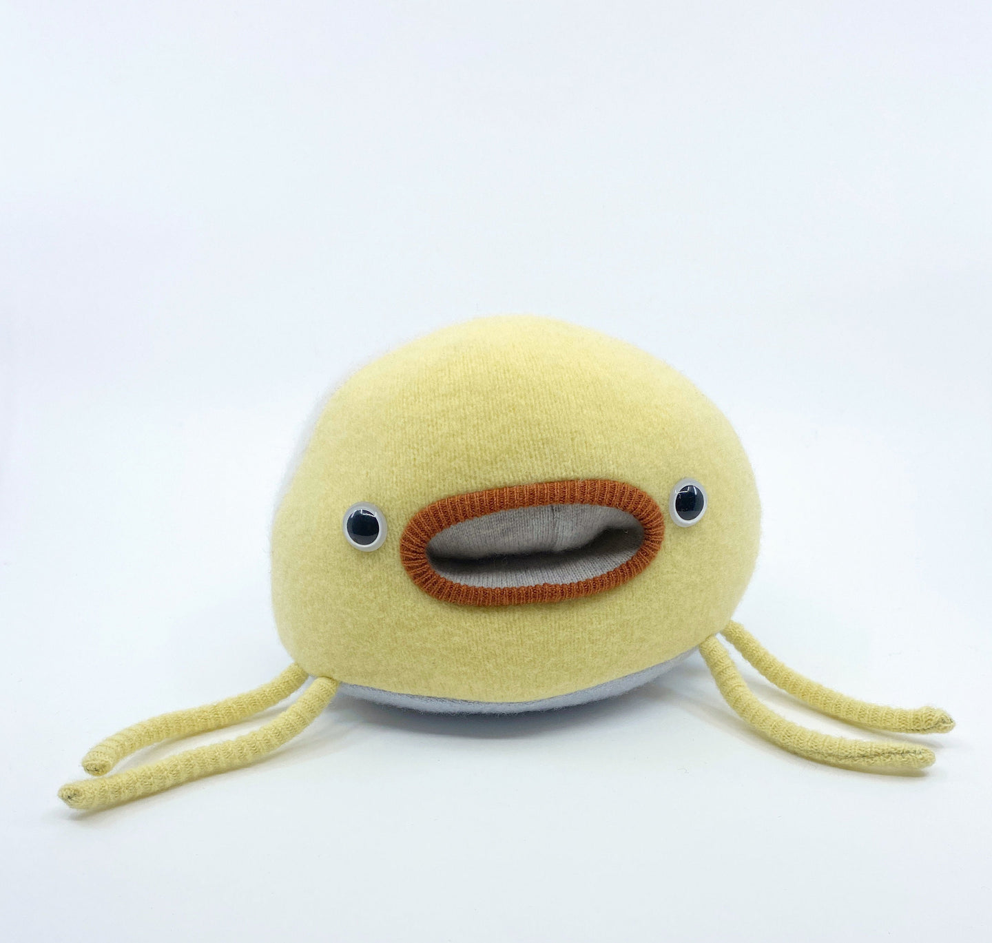 yellow soft and cuddly toy with pocket mouth